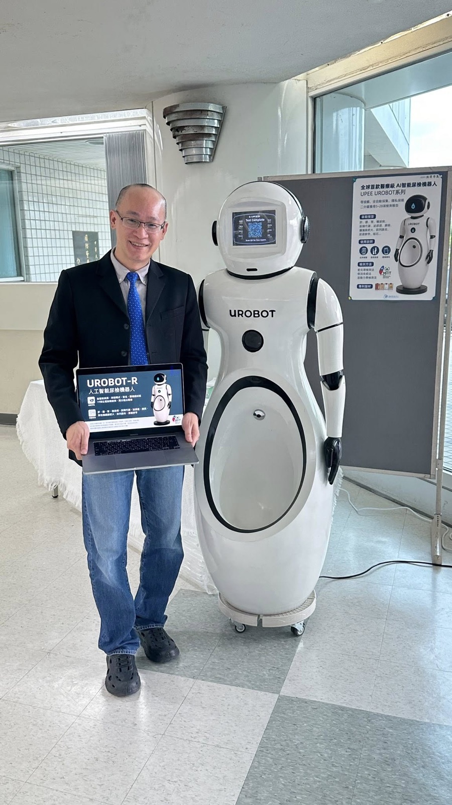 Founder Yaming Jiao with the UROBOT-R humanoid urinalysis robot at an Impressive Care site visit.